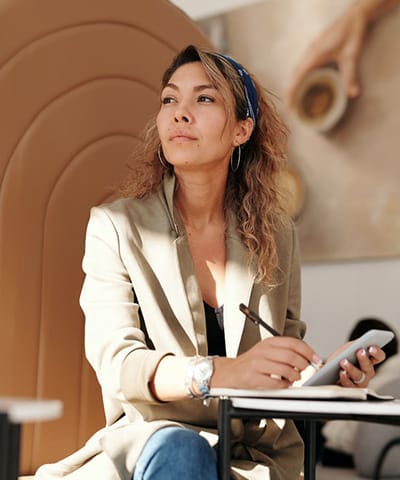 Testimonials woman wearing blazer and blue denim jeans sitting on chair